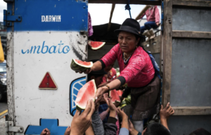 Demonstrators reach out for food donated by supporters in Quito on Oct. 9. (Photo by Jonatan Rosas)